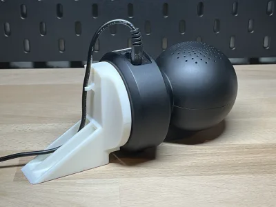 The camera sits in the white mount, the cable running through the clip on the back