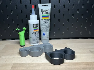 The grey holder on the workbench, behind it the Super Lube and Synco Lube bottles
