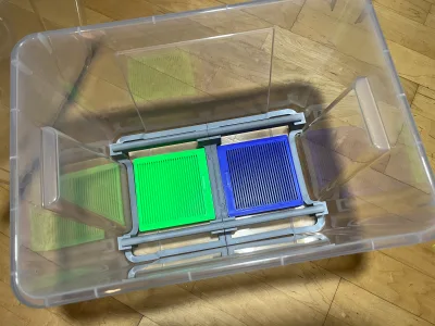 Looking down into the Samla crate: a green and a blue box side by side under the grey spool holder
