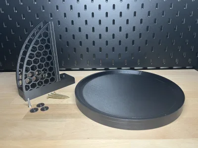 The parts on their own: the round tray, the honeycomb bracket, screws and cover caps